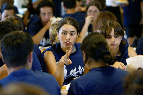 Arab-Israeli Rawan Kamal chats with tablemates during lunch at the Seeds of Peace camp in Otisfield, Maine July 10, 2002.