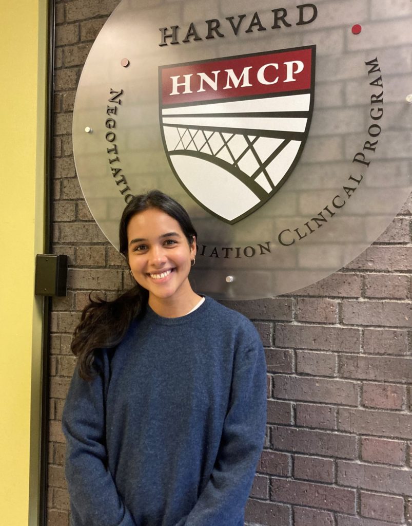 Woman standing in front of HNMCP logo