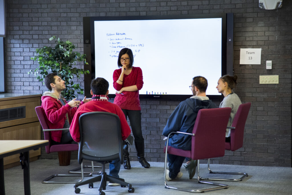 Students collaborating in meeting room